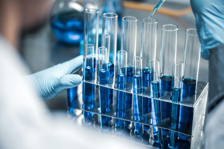 Laboratory researcher handling test tubes during KPV peptide research study