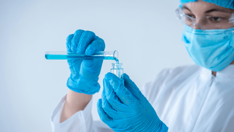 Researcher measuring peptide solution between vials for KLOW and GLOW laboratory comparison research
